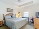 King-size bed, ceiling fan, and dresser in a well-lit bedroom at 5115 Melbourne St # A206, Punta Gorda, FL 33980
