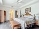 Primary bedroom with king bed, wood furniture, and en-suite bathroom at 5115 Melbourne St # A206, Punta Gorda, FL 33980