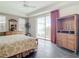 Primary bedroom with king bed, balcony access, and wood dresser at 5115 Melbourne St # A206, Punta Gorda, FL 33980