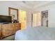 Bedroom with king bed, dresser, and view of en-suite bathroom at 5115 Melbourne St # A206, Punta Gorda, FL 33980