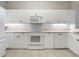White kitchen with microwave, stove, and dishwasher at 5115 Melbourne St # A206, Punta Gorda, FL 33980