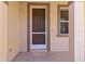 Brown front door with a screen door and sidelight window at 10043 Winding River Rd, Punta Gorda, FL 33950