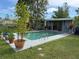 Expansive backyard with a pool and lush greenery at 107 Dunn Ne Dr, Port Charlotte, FL 33952