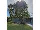 Landscaped backyard featuring mature trees and a pool at 107 Dunn Ne Dr, Port Charlotte, FL 33952