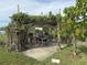 Charming pergola covered in lush vines creates a relaxing outdoor space at 107 Dunn Ne Dr, Port Charlotte, FL 33952