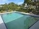 Relaxing rectangular pool with surrounding landscaping at 107 Dunn Ne Dr, Port Charlotte, FL 33952
