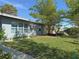 Spacious side yard with lush green grass and bamboo at 107 Dunn Ne Dr, Port Charlotte, FL 33952