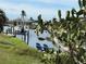 Peaceful waterfront scene with chairs and boat at 107 Dunn Ne Dr, Port Charlotte, FL 33952