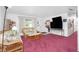 Living room with wicker furniture, coffee table, and pinkish carpet at 1238 Ramsdel St, Port Charlotte, FL 33952