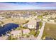 Aerial perspective of a luxurious waterfront condo community with a pool and boat docks at 1349 Aqui Esta Dr # 125, Punta Gorda, FL 33950
