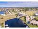 High-angle view of canal-front property with building, boat slips, and surrounding community at 1349 Aqui Esta Dr # 125, Punta Gorda, FL 33950