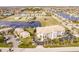 An aerial view showcasing a waterfront condo building with a private pool and boat docks at 1349 Aqui Esta Dr # 125, Punta Gorda, FL 33950