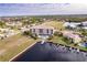 Drone shot showcasing waterfront property, featuring a building, boat slips and community at 1349 Aqui Esta Dr # 125, Punta Gorda, FL 33950