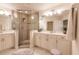 Bathroom with double vanity, large shower, and seating at 1349 Aqui Esta Dr # 125, Punta Gorda, FL 33950