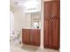 Well-appointed bathroom with wood cabinets and a large mirror at 1349 Aqui Esta Dr # 125, Punta Gorda, FL 33950