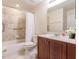 Clean bathroom with tub, shower, and wood vanity at 1349 Aqui Esta Dr # 125, Punta Gorda, FL 33950