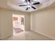 Bedroom with kitchen view and ceiling fan at 1349 Aqui Esta Dr # 125, Punta Gorda, FL 33950