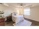 Cozy bedroom with a queen bed and hardwood floors at 1349 Aqui Esta Dr # 125, Punta Gorda, FL 33950