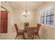 Charming dining area with glass table and rattan chairs at 1349 Aqui Esta Dr # 125, Punta Gorda, FL 33950