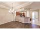 Bright dining room featuring hardwood floors and a chandelier at 1349 Aqui Esta Dr # 125, Punta Gorda, FL 33950