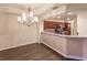 Elegant dining room with hardwood floors and a chandelier at 1349 Aqui Esta Dr # 125, Punta Gorda, FL 33950