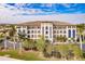 Attractive three-story building with palm trees and landscaping at 1349 Aqui Esta Dr # 125, Punta Gorda, FL 33950