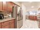 Modern kitchen with stainless steel appliances and wood cabinets at 1349 Aqui Esta Dr # 125, Punta Gorda, FL 33950