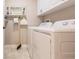 Bright laundry room with washer, dryer, and storage at 1349 Aqui Esta Dr # 125, Punta Gorda, FL 33950