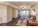 Bright living room with hardwood floors, comfy seating, and access to balcony at 1349 Aqui Esta Dr # 125, Punta Gorda, FL 33950