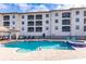 Refreshing community pool and spa with ample seating at 1349 Aqui Esta Dr # 125, Punta Gorda, FL 33950