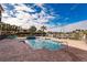 Inviting pool and spa area with brick patio, and lounge chairs at 1349 Aqui Esta Dr # 125, Punta Gorda, FL 33950