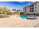 Community pool and spa with patio and building view at 1349 Aqui Esta Dr # 125, Punta Gorda, FL 33950