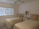 Bedroom with two twin beds and ceiling fan at 1360 Rio De Janeiro Ave # 117, Punta Gorda, FL 33983