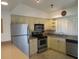 Bright kitchen features stainless steel appliances and light cabinets at 1360 Rio De Janeiro Ave # 117, Punta Gorda, FL 33983