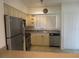 Bright kitchen features stainless steel appliances and light cabinets at 1360 Rio De Janeiro Ave # 117, Punta Gorda, FL 33983