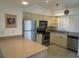Bright kitchen features stainless steel appliances and light cabinets at 1360 Rio De Janeiro Ave # 117, Punta Gorda, FL 33983