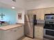 Kitchen with stainless steel appliances and light cabinets at 1360 Rio De Janeiro Ave # 117, Punta Gorda, FL 33983