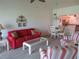 Living room with red sofa and striped armchairs at 1360 Rio De Janeiro Ave # 117, Punta Gorda, FL 33983