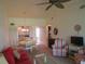 Living room featuring red sofa, striped chairs, and dining area at 1360 Rio De Janeiro Ave # 117, Punta Gorda, FL 33983