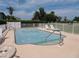 Community pool with lounge chairs and surrounding fence at 1360 Rio De Janeiro Ave # 117, Punta Gorda, FL 33983