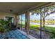 Screened patio overlooks a serene lake and lush landscape at 14009 Black Beauty Dr # 212, Punta Gorda, FL 33955