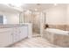 Spa-like bathroom with double vanity, walk-in shower, and soaking tub at 14009 Black Beauty Dr # 212, Punta Gorda, FL 33955
