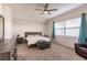 Spacious bedroom with a king-size bed, ceiling fan, and large windows at 14009 Black Beauty Dr # 212, Punta Gorda, FL 33955