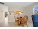 Small dining area with wood table and chairs at 1512 Rio De Janeiro Ave # 111, Punta Gorda, FL 33983