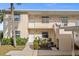 Two-story condo building with landscaped grounds and walkway at 1512 Rio De Janeiro Ave # 111, Punta Gorda, FL 33983
