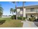 Condo building exterior with parking and landscaping at 1512 Rio De Janeiro Ave # 111, Punta Gorda, FL 33983