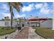 Brick pathway leads to a boat lift with a red and white boat on it at 1610 Montia Ct, Punta Gorda, FL 33950