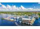 Aerial view of a marina and waterfront restaurant with boats and blue skies at 1650 W Marion Ave # 144, Punta Gorda, FL 33950