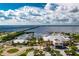 Aerial view of waterfront area with restaurant, marina, and bridge in the background at 1650 W Marion Ave # 144, Punta Gorda, FL 33950