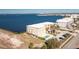 Aerial perspective of a waterfront building with pool, parking and nearby road at 1650 W Marion Ave # 144, Punta Gorda, FL 33950